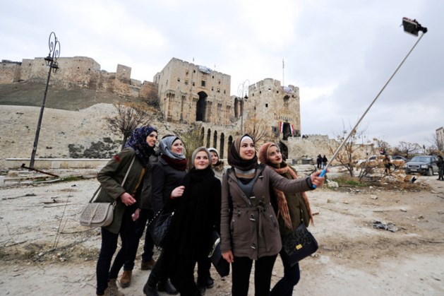 'Toeristen' poseren met glimlach tussen het puin van Aleppo