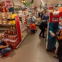 Voetballers van vier clubs vullen vakken bij de supermarkt: zo helpen ze hun sponsor december door